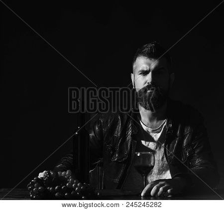 Winetasting And Degustation Concept. Sommelier Tastes Expensive Drink. Man With Beard Holds Glass Of