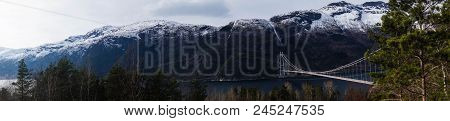 A Long Bridge Across The Hardangerfjord In Norway