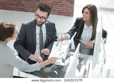 assistant passes business woman working document