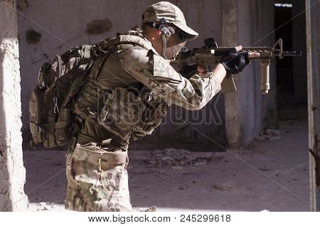 Soldier Back Pack Rifle Hold On Hands And Aim Red Dot