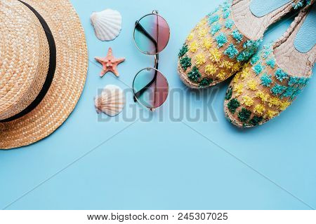 Summer Fashion Flatlay With Gradient Round Sunglasses, Straw Hat And Espadrille Sandals On The Blue 