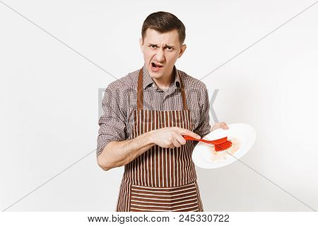 Young Man Chef In Striped Brown Apron, Shirt Holds Washes White Round Empty Dirty Plate With Red Bru