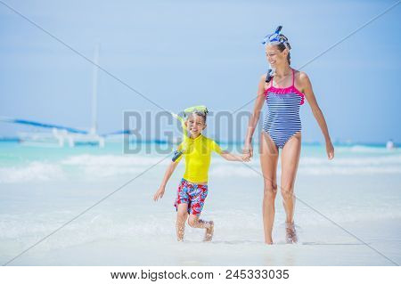 Brother And Sister Runing And Having Fun On The Beach During The Hot Summer Vacation Day.
