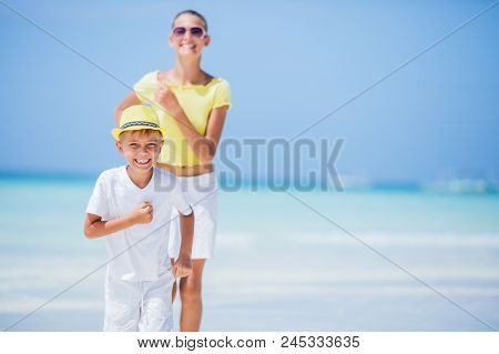 Brother And Sister Runing And Having Fun On The Beach During The Hot Summer Vacation Day.