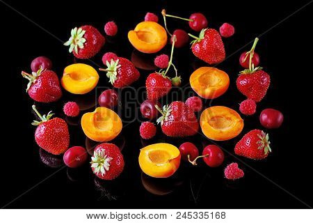 Berries: Strawberries, Blueberries, Raspberries, Apricot, Cherry Fruits On A Black Background Close-