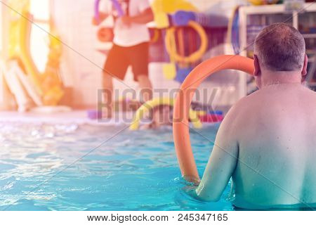 Group Or Young And Senior People In Aquarobic Fitness Swimming Pool Exercising Water Sport