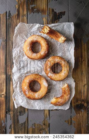Homemade Puff Pastry Deep Fried Donuts Or Cronuts In Stack With Sugar Standing On Crumpled Paper Ove