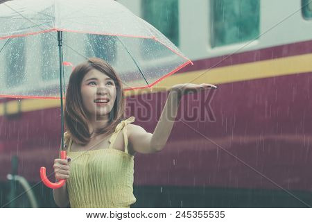 Woman Holding Umbrella In Rainy Day. Asian Girl On Spring Season At Train Station. Lady Happy Rainy 