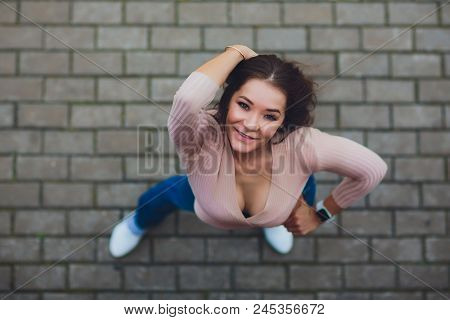 Young Smiling Teen Girl Looking At Camera. Shot From Above.