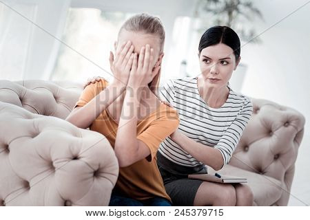 Being Destroyed Morally. Portrait Of Sad Light Haired Girl Keeping Hand On Her Face While Experience