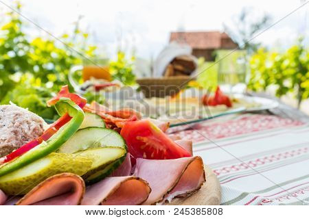 Brettljause, Traditional Cold Plate With Meat, Cheese, Fish, Vegetable, Bread And Drinks On Wooden T