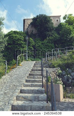 2018, 12 May, Banyalbufar, Majorca, Spain. Stone Stairs With Wooden Rail And Lush Greenery.  Banyalb