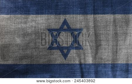 Flag Of Israel On Jeans Denim Texture Background Close Up .