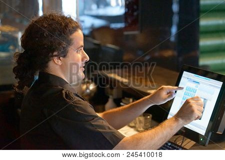 Registration Male Of Bartender Employee Of A New Order By A Cash Register. The Barman Pays The Order