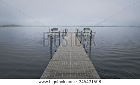 Dock With Benches On Foggy Lake Irving In Bemidji Minnesota