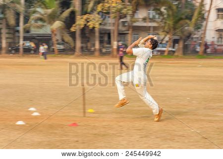 A Boy Practicing Fast Bowling To Improve Cricketing Skills At Mumbai Grounds