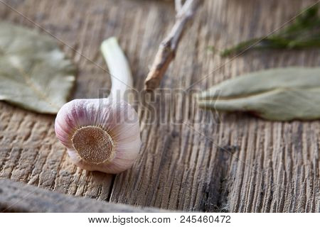 Organic Bay Leaf And Garlic On Wooden Board, Top View, Close-up, Selective Focus. Natural Organic Se