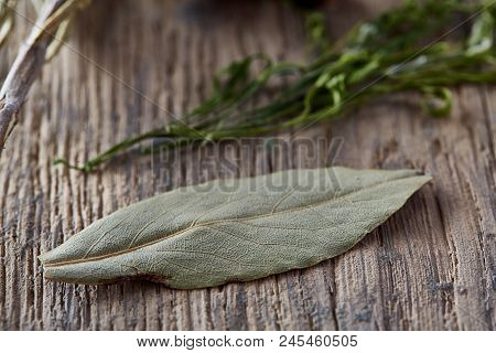 Bay Leaf And Parsley On Wooden Board, Top View, Close-up, Selective Focus. Natural Organic Seasoning