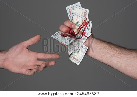 Hand Injured Bloody Finger Holds Dollar Banknote Grey Background. Dirty Money Concept. Bloody Curren