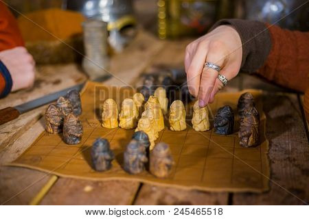 Close Up Shot - Two Men In Russian Ethnic Suit Playing Medieval Popular Strategy Board Game - Tafl. 