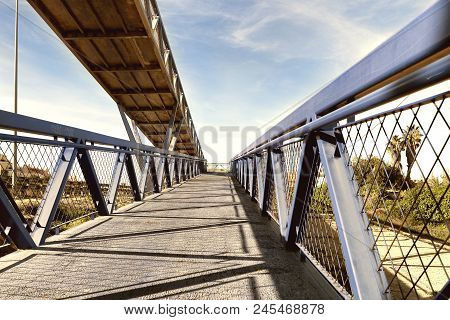 Blue Steel Bridge Across The Road For People And Bycles In Guardamar Del Segura, Alicante. Spain