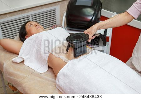 Woman Getting Cryolipolysis Fat Treatment Procedure In Professional Cosmetic Cabinet Or Spa Center, 