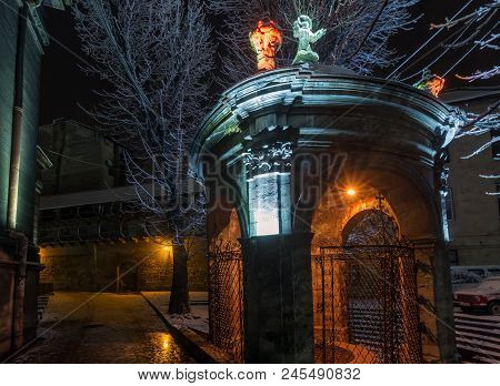 Beautiful Night Winter Lviv City (ukraine) Illuminated Cityscape. Well Of Saint John Of Dukla In The