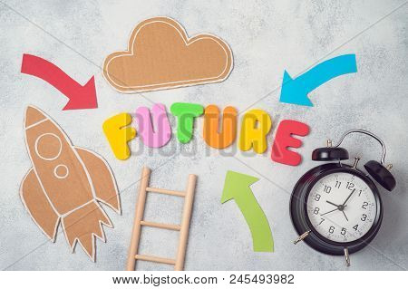 Future Concept. Letters, Rocket, Cloud. Alarm Clock And Arrows Over Gray Background. View From Above