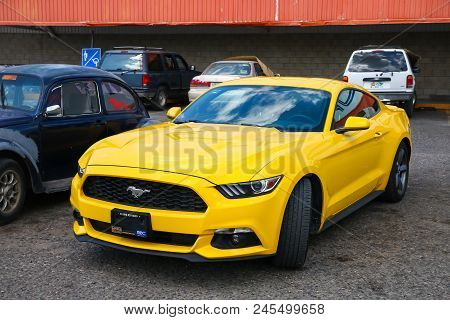 Palenque, Mexico - May 22, 2017: Yellow Muscle Car Ford Mustang In The City Street.