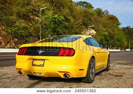 Acapulco, Mexico - May 28, 2017: Yellow Muscle Car Ford Mustang In The City Street.