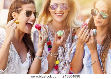 Happy girl friends hanging out in the city in summer