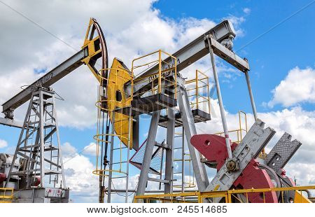 Tatarstan, Russia - June 10, 2018: Working Pump Jack Fracking Crude Extraction Machine. Oil Industry