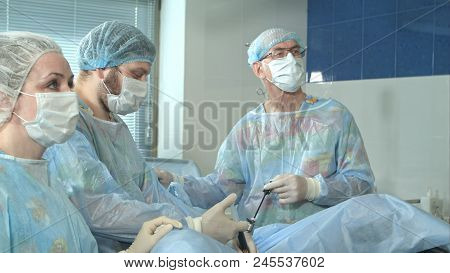 Medical Staff In The Opearing Room Doing Sucessful Surgical Procedure