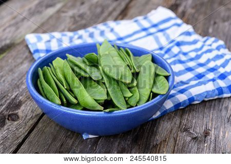 Blue Bowl With Green Peapods And Towel