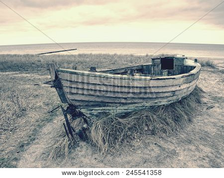 Fishermens Boat At Seacoast, On Sand At Sunset With Horizon Sea On Background. Background Of Sea Wit
