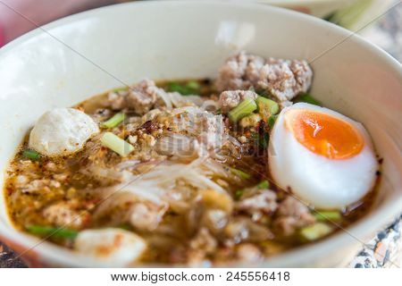 Spicy Tom Yum Noodle With Pork And Egg For Sale At Thai Street Food Market Or Restaurant In Thailand