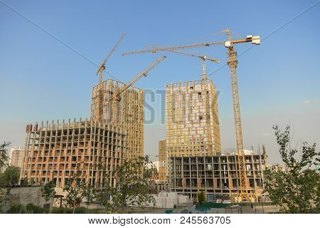 Hoisting Crane And New Multi-storey Building. Ndustrial Background. Construction Of High-rise Houses