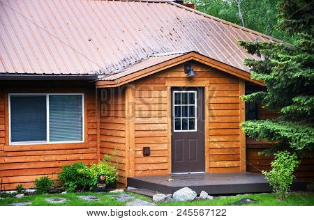Front of rental cabin with cedar plank siding
