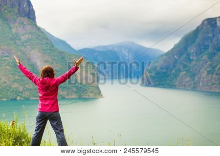 Travel Concept. Happy Free Tourist Woman In Happiness And Elated Enjoyment With Arms Raised Outstret