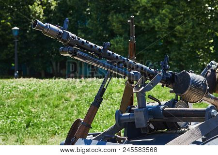 The Machine Gun Is Fixed On The Buggy Of The Motorcycle. Rifles Are Leaning Against The Buggy Of A M