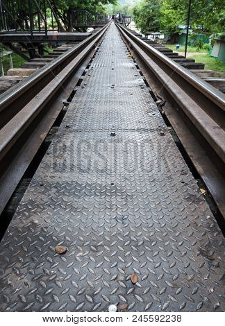 Closeup Of The Metal Pathway On The Old Railway Bridge With The Blur Trourist Background, Kanchanabu