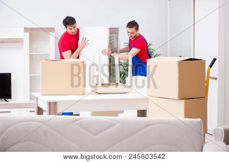 Two contractor employees moving personal belongings