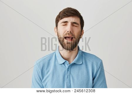 Waist-up Shot Of Upset Handsome Caucasian Guy In Shirt, Whining Or Crying As If He Is Baby, Standing