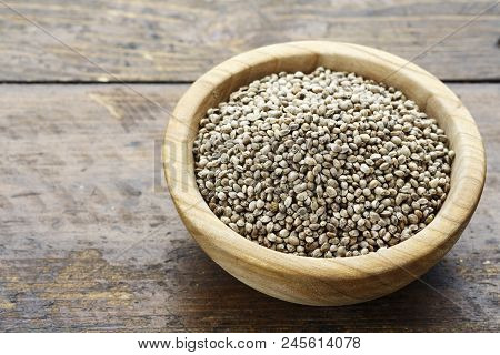 Cannabis Seeds In A Plate Close-up On A Wooden Background, Space For Text