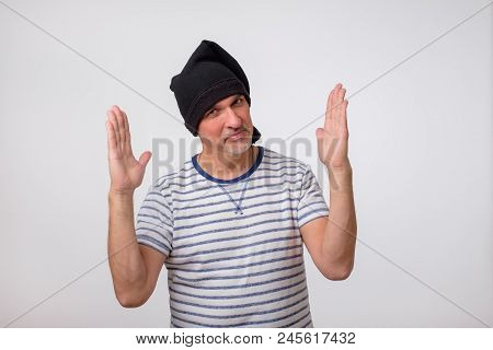 Portuguese Fisherman In Black Cap Showing Size Of Fish. He Boasts Of The Size Of His Prey. He Exagge
