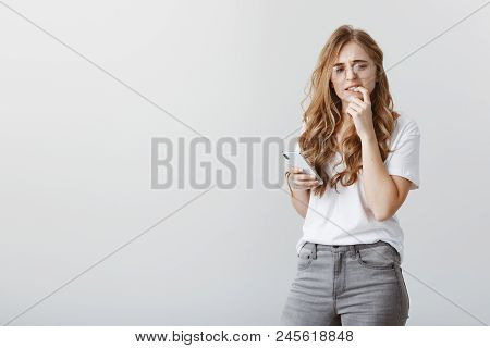 Anxious And Insecure In Herself. Worried Good-looking European Woman With Blond Hair In Trendy Glass