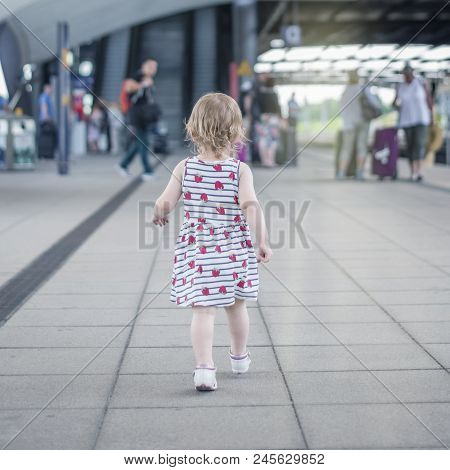 Little Girl The Child Briskly Walks Along The Crowded Perron To The Excavator, The Rear View