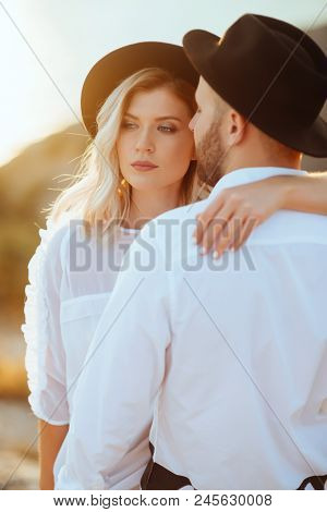 Romantic Summer Love Story On A Sunset In Mountains. Young Girl And Boy In Love.
