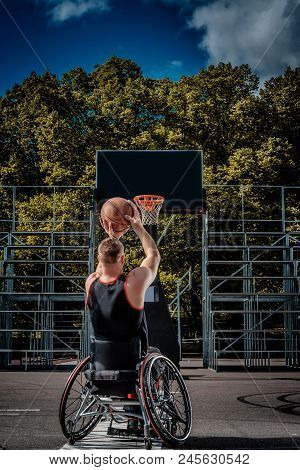 Cripple Basketball Player In A Wheelchair Plays On An Open Gaming Ground.