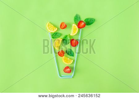 Creative Layout Strawberry Lemonade Ingredients - Lemon, Mint, Berries Falling In Glass Made With Co